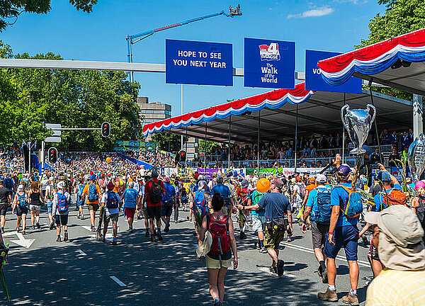 Intocht van de vierdaagse Nijmegen met een bontgekleurde stoet