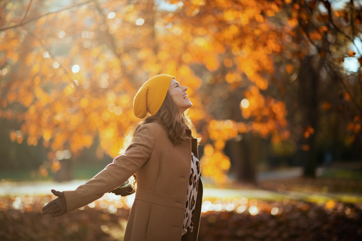 vrouw in herfstbos die inademt