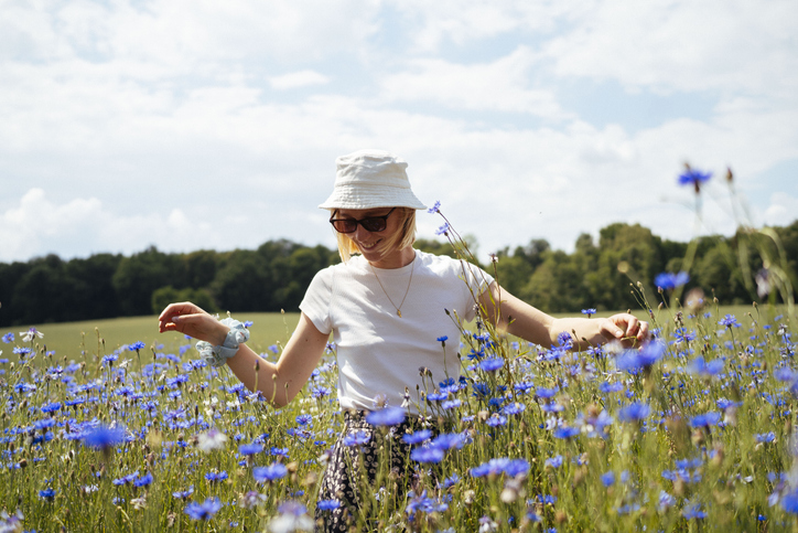Ontspannen vrouw in een veld korenbloemen